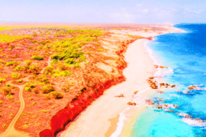 James Price Point, Broome. Red Cliffs, Turquoise Waters and Remote Coastal Beauty Stunning view of red cliffs and blue ocean at James Price Point near Broome, WA, with sandy beach and rugged outback scenery.